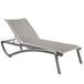 A Grosfillex Sunset Platinum Gray chaise lounge with a solid gray sling seat.