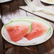 A Solo paper plate with watermelon slices on a table.