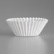 A close-up of a white paper fluted mini baking cup.