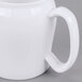 A close-up of a white Cambro contoured mug with a handle.
