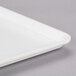 A close-up of a white MFG Tray Supreme display tray.