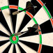 A close-up of a dart in the bullseye of a Nodor dartboard.