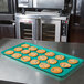 A MFG Tray mint green fiberglass display tray holding cookies on a counter.
