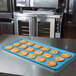 A sky blue MFG Fiberglass Supreme Display Tray holding chocolate chip cookies on a table.