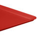 A red MFG Tray Supreme display tray on a table.