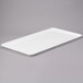 A white rectangular MFG Tray display tray on a gray surface.