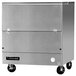 A stainless steel Continental Refrigerator milk cooler with wheels and a door.