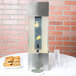 A Cal-Mil acrylic beverage dispenser chamber with a drink dispenser and cookies inside.