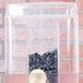 A clear Cal-Mil beverage dispenser lid on a container with blueberries inside.