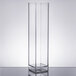 A clear rectangular object with a stand inside a white room.