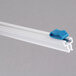 A white plastic strip with a blue plastic clip.