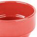 A close up of a Libbey Cayenne porcelain bouillon bowl with a red surface.