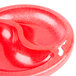 A red plastic divided bowl with two sections.