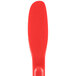 A red polypropylene sandwich spreader with a paddle end.