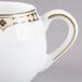 A white Syracuse China Baroque creamer with gold trim and a handle.