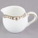 A white and gold Syracuse China creamer with a Baroque design.