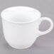 A Libbey white porcelain tea cup with a handle on a gray background.