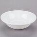 A Libbey white porcelain cereal bowl with a small rim on a gray surface.