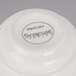 A Libbey Savoy ivory porcelain stacking cup with a black word and logo.