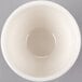 A Libbey ivory porcelain bouillon bowl filled with white liquid.