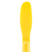 A yellow plastic sandwich spreader with a handle.