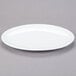 A white oval Libbey porcelain coupe platter on a gray surface.