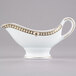 A white Syracuse China sauce boat with gold trim.