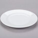A Libbey white porcelain plate with a rim on a gray surface.