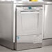 A stainless steel Hobart LXeH-1 undercounter dishwasher on a counter in a professional kitchen.