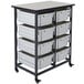 A white and black Luxor storage bin cart with large white bins on it.