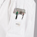 A white Mercer Culinary chef coat with red piping and a pocket full of medical tools.