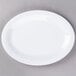 A Diamond White oval melamine platter on a gray surface.