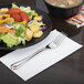 A plate of salad with a Libbey stainless steel dessert fork.