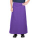 A person wearing a purple Intedge bistro apron with pockets.