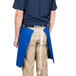 A man wearing a blue Intedge waist apron.