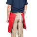 A man wearing a red Intedge waist apron.