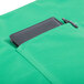 A black rectangular object in a pocket on a green Intedge bistro apron.
