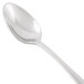 A close-up of a Libbey stainless steel teaspoon with a white handle.