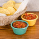 Two GET Diamond Mardi Gras melamine ramekins filled with salsa on a table with a basket of chips.