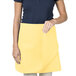 A woman wearing a yellow Intedge waist apron.