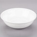 A 10 Strawberry Street Bistro bright white porcelain fruit bowl on a gray surface.