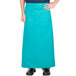 A person wearing a teal Intedge bistro apron with pockets.