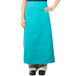A woman wearing a teal Intedge bistro apron with pockets.