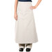 A woman wearing an ivory Intedge bistro apron with pockets.