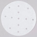 A white round patty paper with perforations in it.
