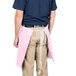 A person wearing a pink Intedge waist apron.