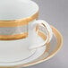 A 10 Strawberry Street Elegance white porcelain cup with a gold rim on a saucer.