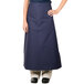 A woman wearing a navy blue Intedge bistro apron with pockets.