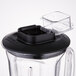 A black Waring blender jar with a lid on top.