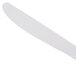 A close-up of a Libbey Neptune dinner knife with a white handle.